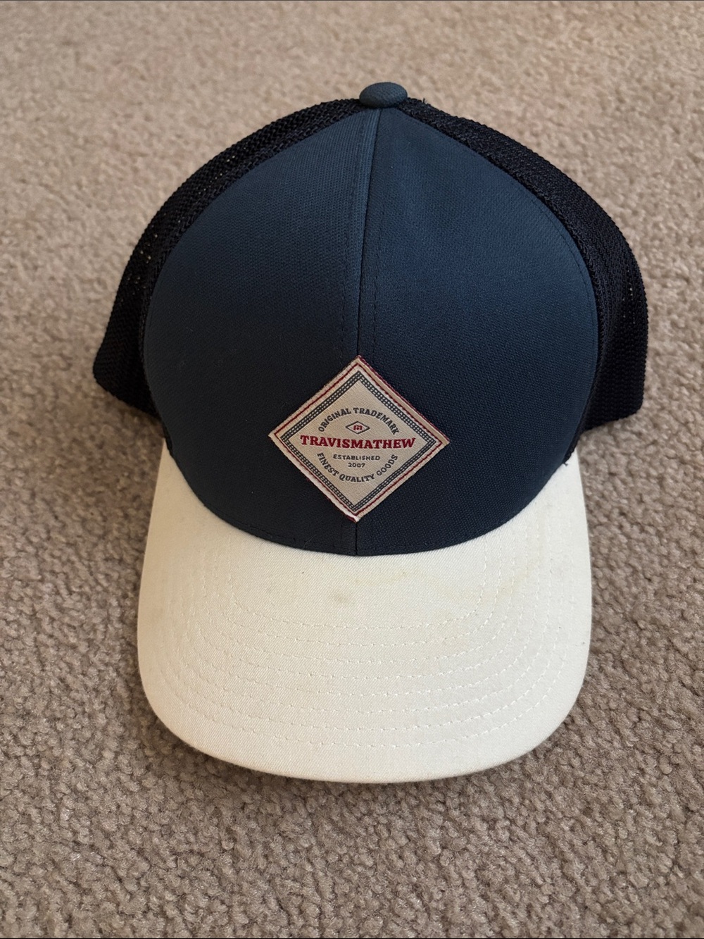 Travis Mathew Navy Crown Cream Bill Mesh Trucker Hat